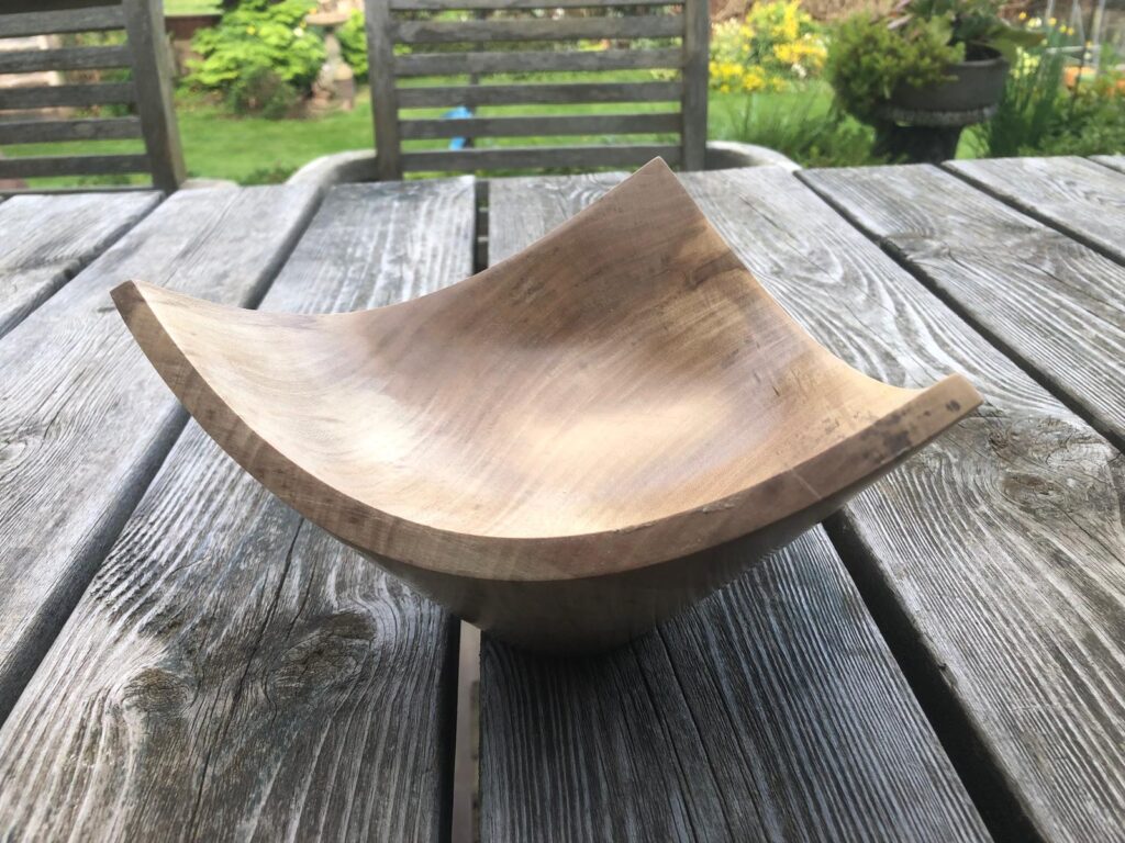 A three cornered wooden bowl in Holly
